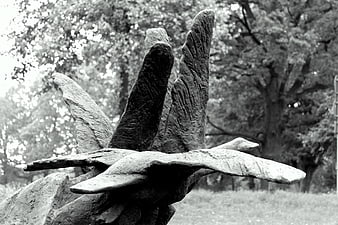Black and white sculpture of a bird in flight