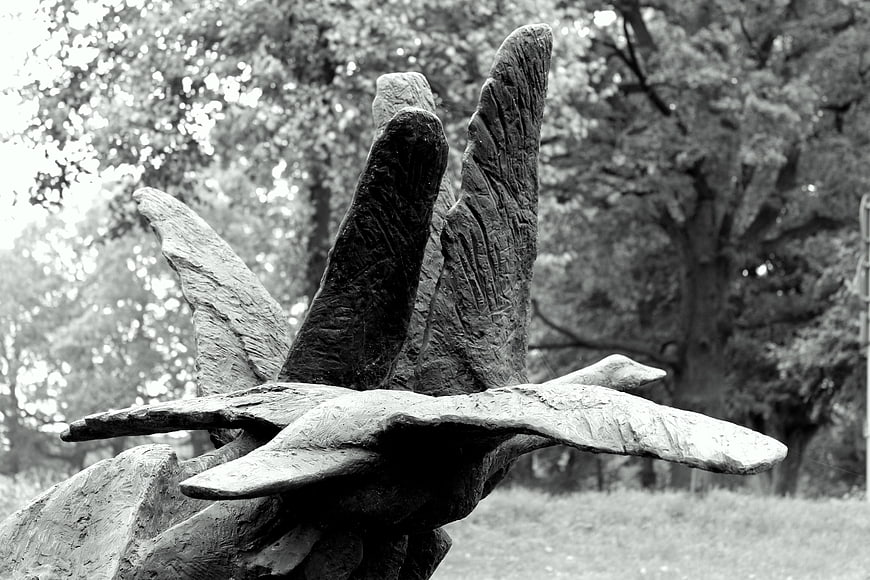 Black and white sculpture of a bird in flight