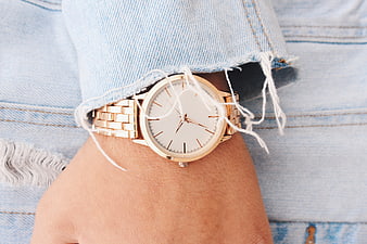 Gold Watch on Wrist with Denim Sleeve