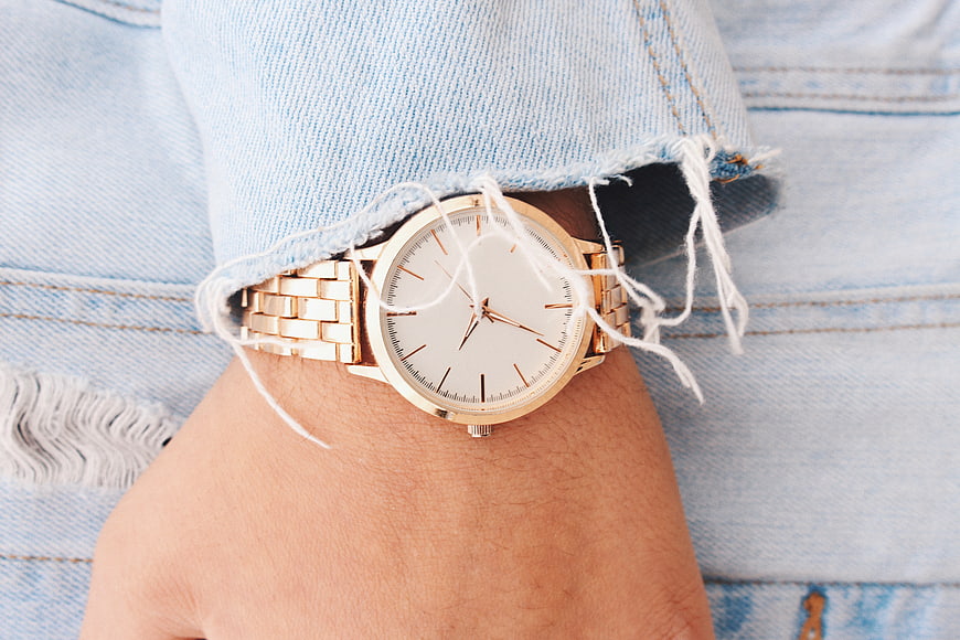 Gold Watch on Wrist with Denim Sleeve