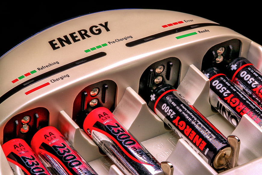 Close-up of AA rechargeable batteries in a silver energy charger