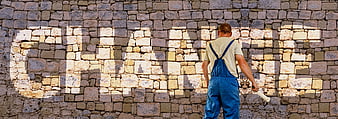 Painter projecting choice word on stone wall