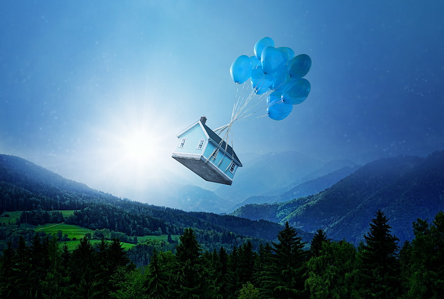Surreal Floating House With Blue Balloons Over Mountain Landscape