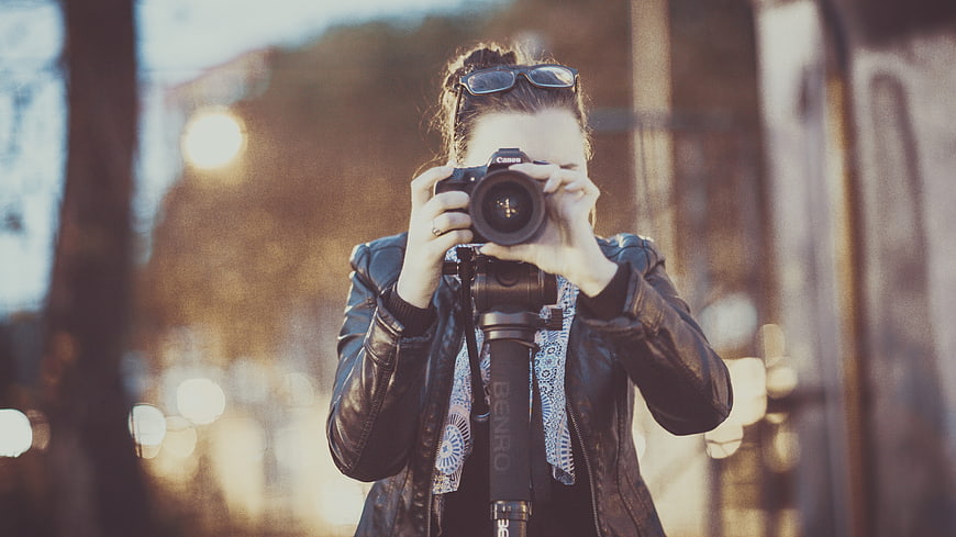 Woman Photographer Taking Photo with DSLR Camera Outdoors