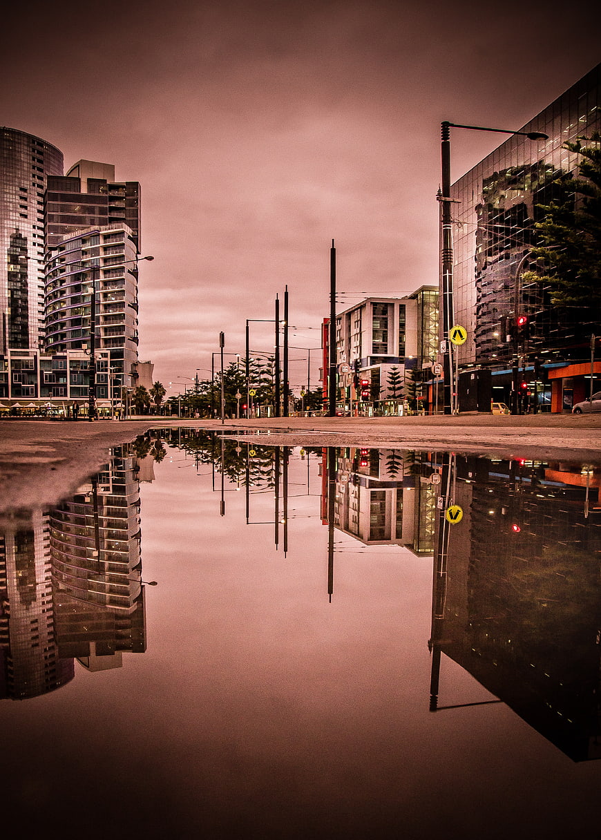 Urban Cityscape Reflection in Puddle at Dusk