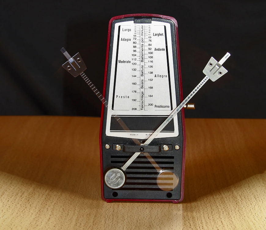 Vintage mechanical metronome on wooden table