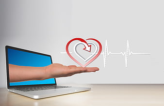 Hand holding heart icon and pulse line emerging from laptop screen