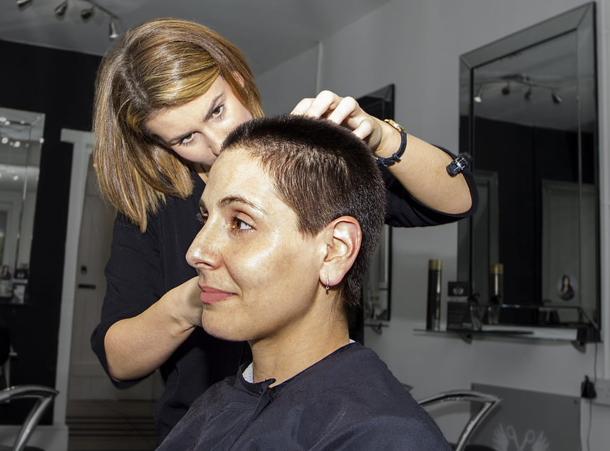 Female Hairdresser Styling Short Hair in Salon