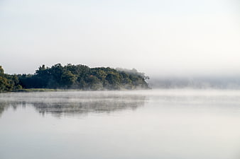 Serene Misty Lake Landscape with Forest Reflection