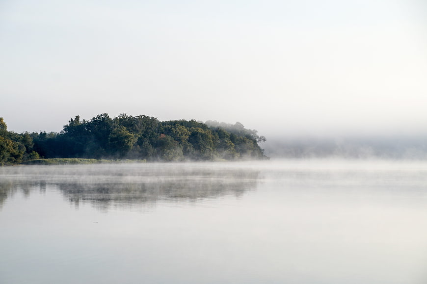 Serene Misty Lake Landscape with Forest Reflection