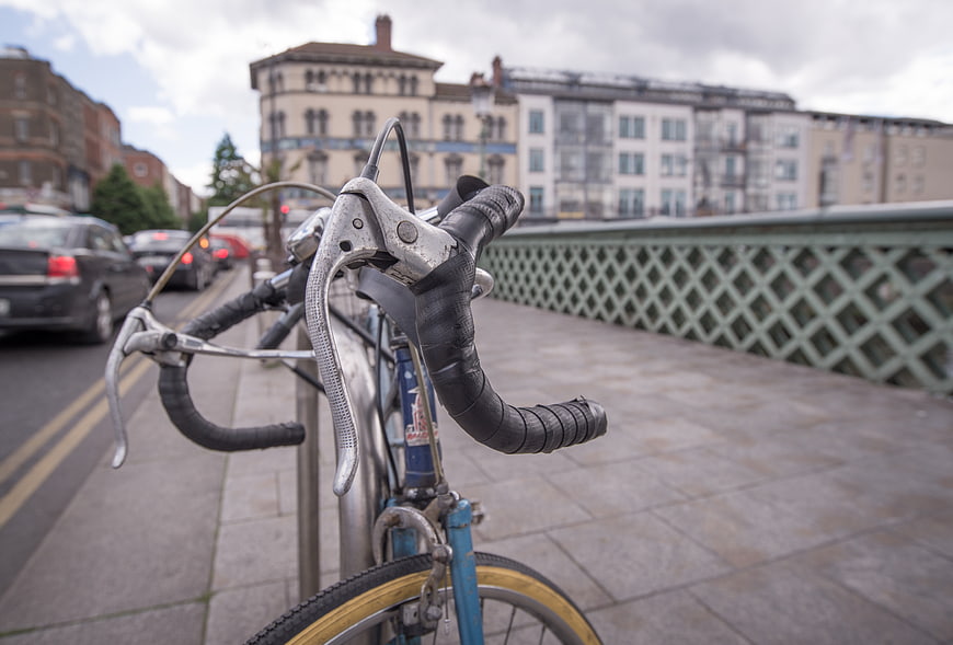 Close-up of vintage bicycle handlebars on a city bridge