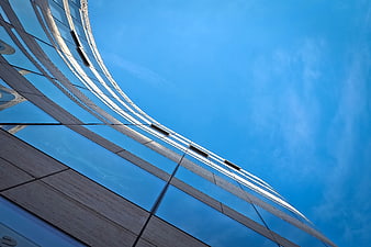 Modern Glass Skyscraper Facade Against Blue Sky
