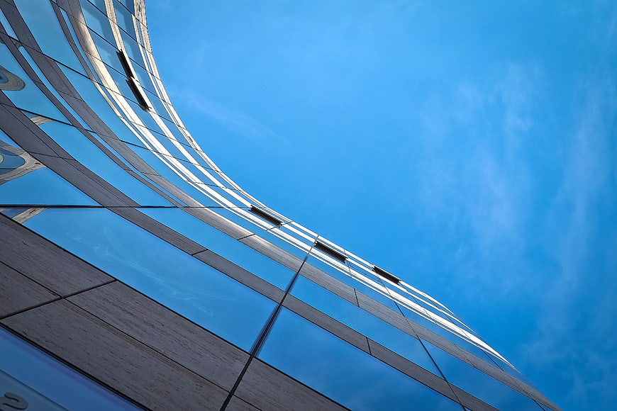 Modern Glass Skyscraper Facade Against Blue Sky