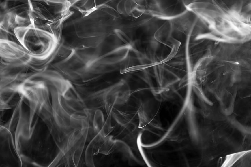 Abstract Black And White Smoke Swirls On Dark Background