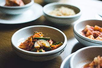 Close-up of Korean side dishes in ceramic bowls