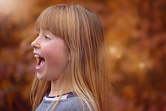 Profile Portrait Of Young Girl Yelling With Autumn Background