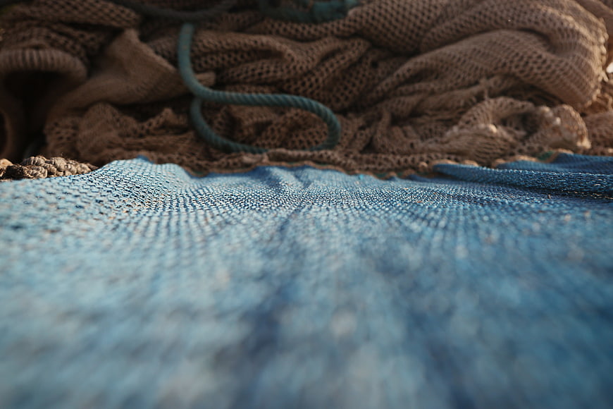 Close-up of blue and brown fishing nets with rope
