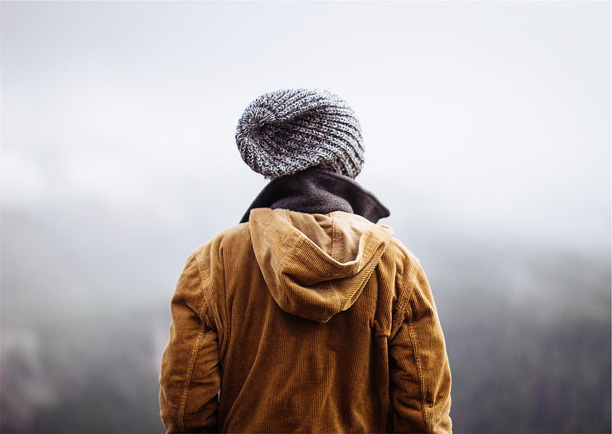 Man in Beanie and Corduroy Jacket Looking at Foggy View