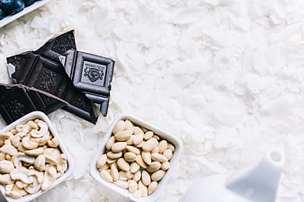 Dark chocolate, cashews, and almonds on coconut flakes