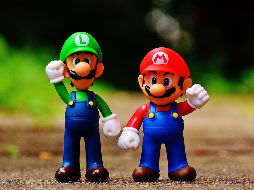 Mario and Luigi figurines standing on a path