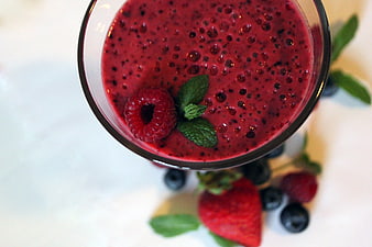 Top-Down View of Red Berry Smoothie Garnished with Raspberry and Mint