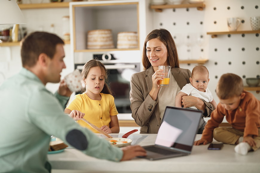 Happy family having breakfast together in modern kitchen