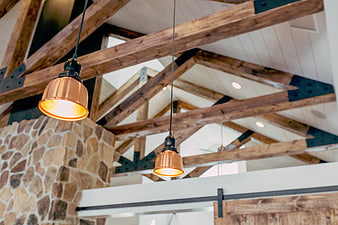 Rustic Interior with Copper Pendant Lights and Wooden Beams