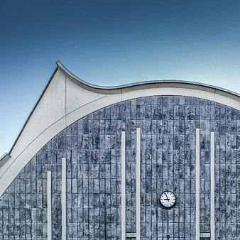 Modern architectural detail with curved roof and clock