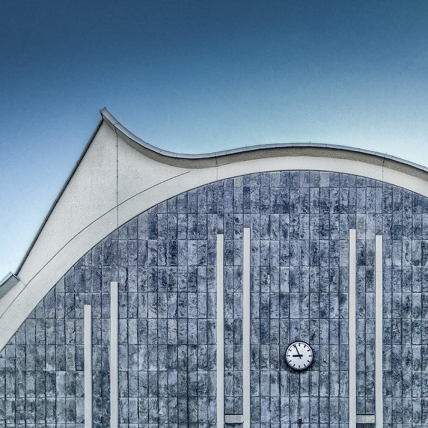 Modern architectural detail with curved roof and clock