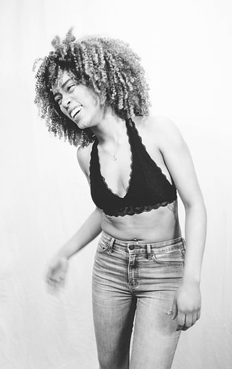 Black and white portrait of a laughing woman with curly hair