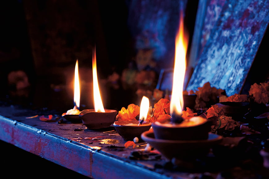 Traditional Oil Lamps Burning on a Religious Altar at Night