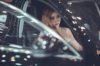 Woman in Sparkling Dress Sitting in Luxury Car