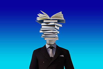 Conceptual businessman with stack of books for head on blue background