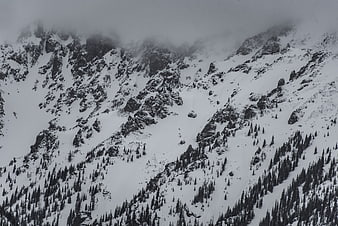 Snowy Mountain Peaks Obscured by Low Hanging Clouds