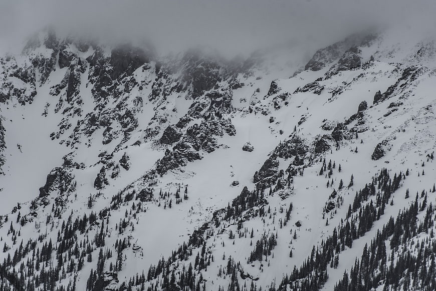Snowy Mountain Peaks Obscured by Low Hanging Clouds