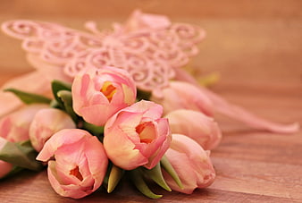 Pink Tulip Bouquet With Butterfly Ornament On Wooden Surface