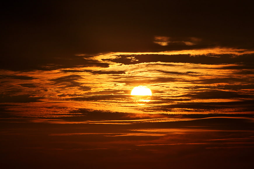 Dramatic Orange Sunset Sky with Layered Clouds