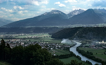 Panoramic View of Alpine Valley with River and Mountains
