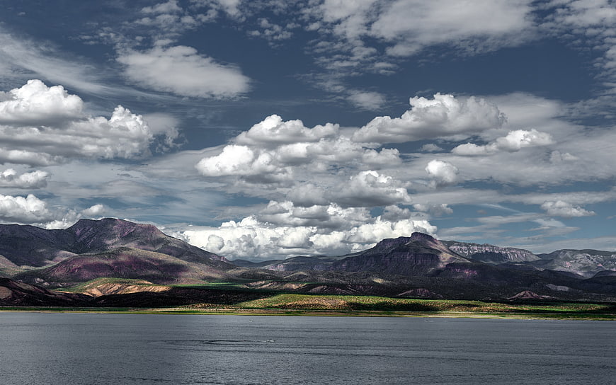 Dramatic mountain landscape with lake and cloudy sky