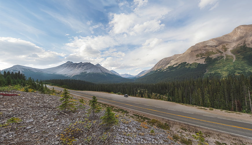 Scenic mountain highway winding through forest valley