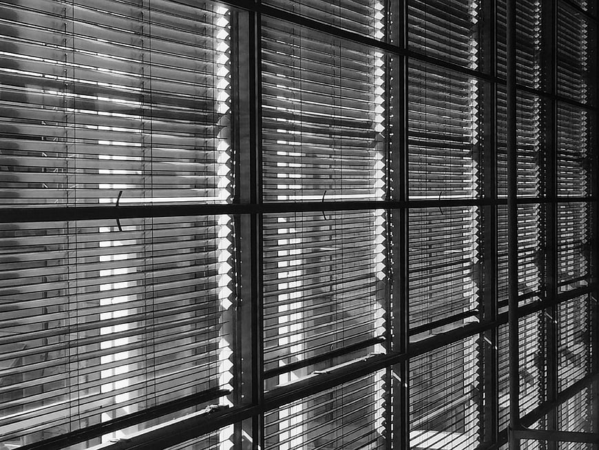 Black and white abstract pattern of window blinds and shadows