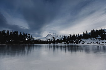 Serene Winter Landscape with Snowy Mountain and Frozen Lake