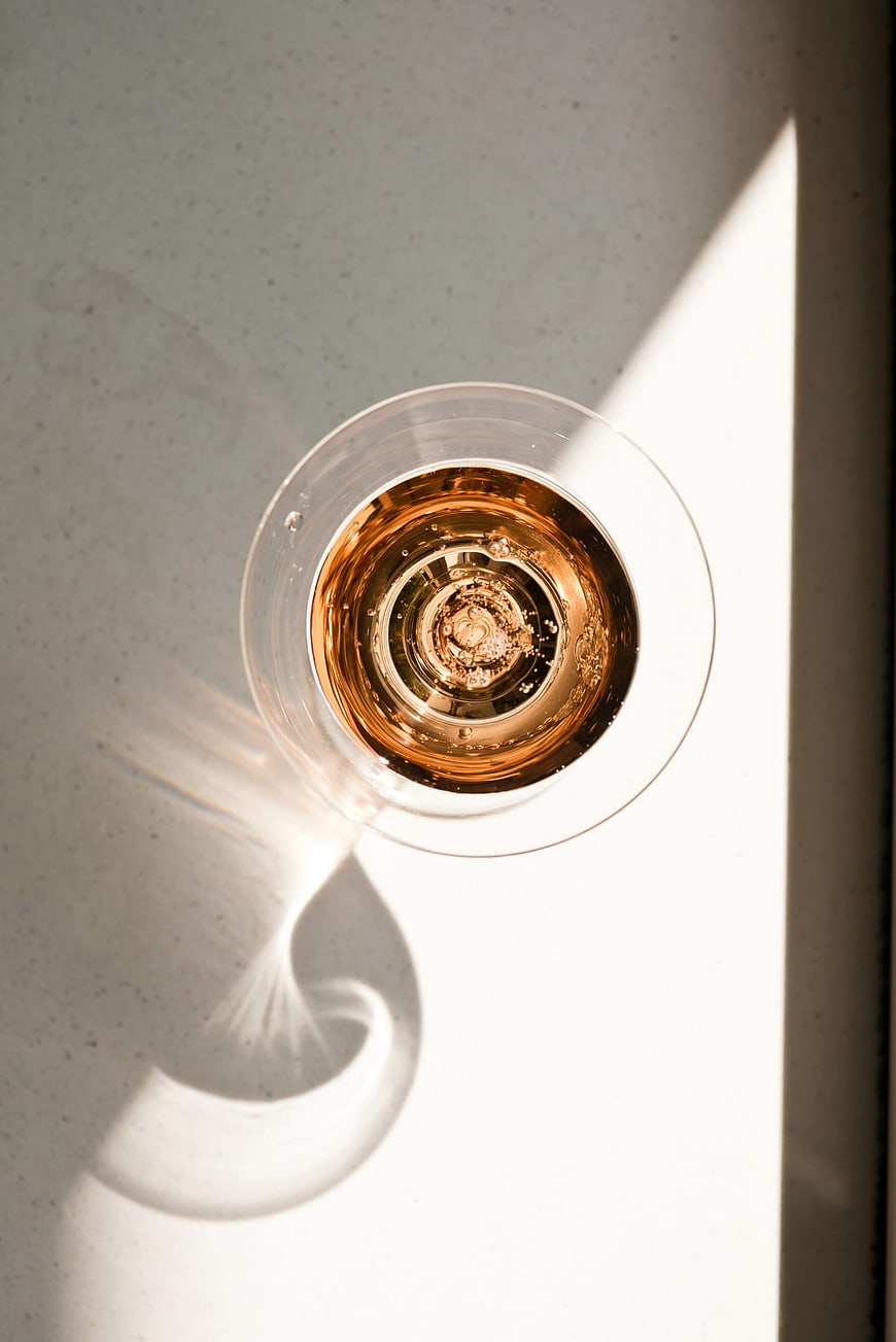 Top View of Rosé Wine Glass with Sunlight Shadow