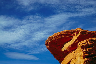 Red Rock Formation Against Blue Sky with Clouds