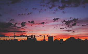 Industrial Silhouette Against Vibrant Sunset Sky