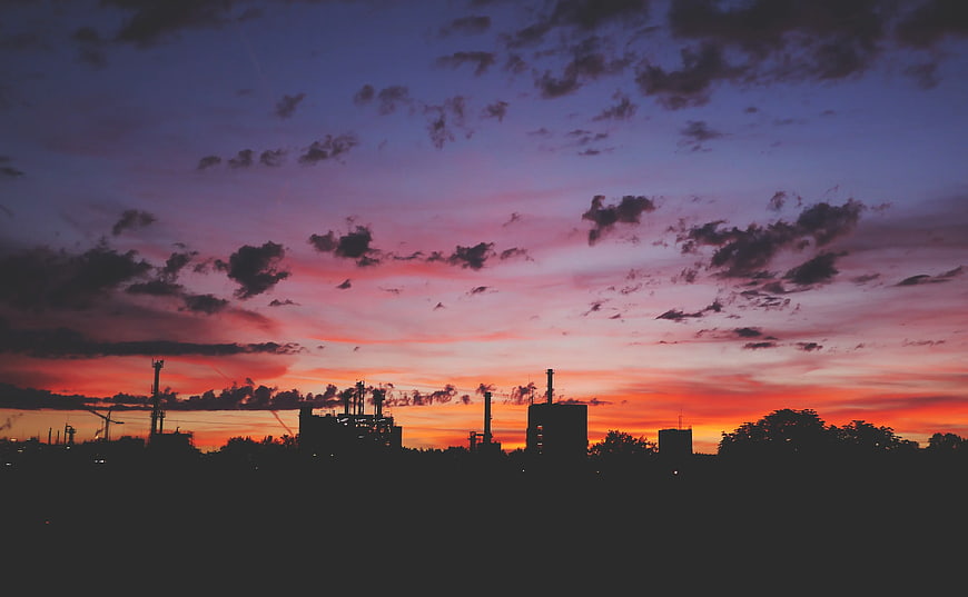 Industrial Silhouette Against Vibrant Sunset Sky