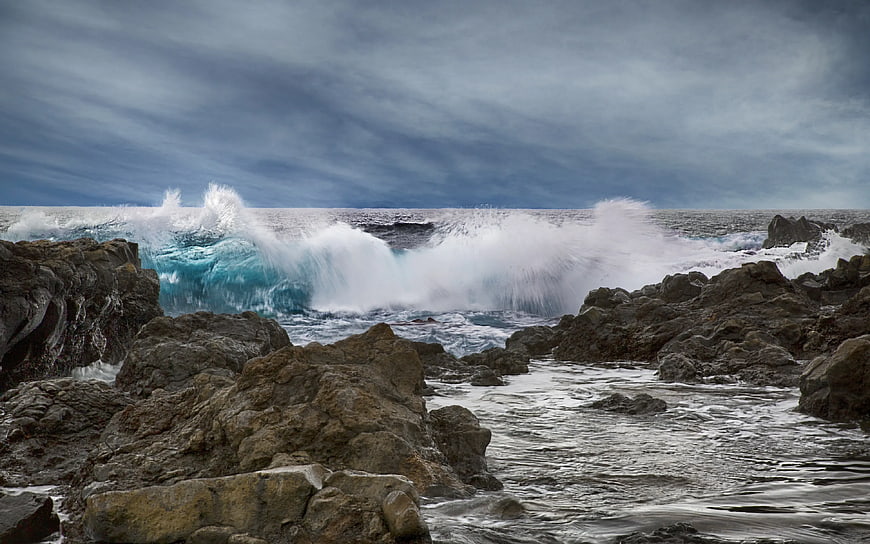Powerful Ocean Waves Crashing Against Rocky Coastline
