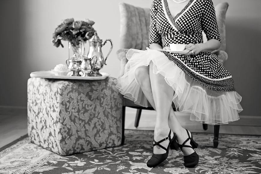Vintage Black and White Tea Party Scene with Woman in Polka Dot Dress