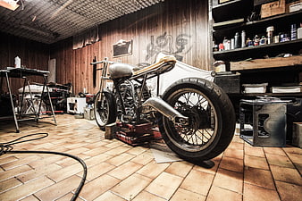 Custom chopper motorcycle in rustic workshop garage