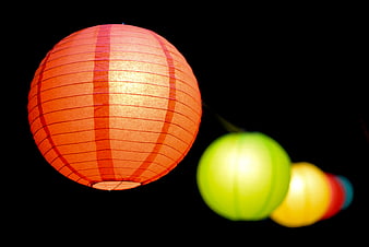 Glowing Red Paper Lantern Against Black Background